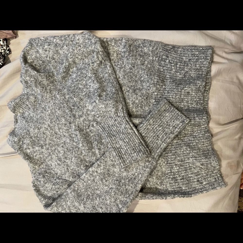 Grey high neck shirt.